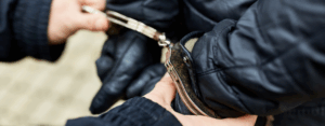 Hands in handcuffs for the Unlock drama blog about reducing reoffending